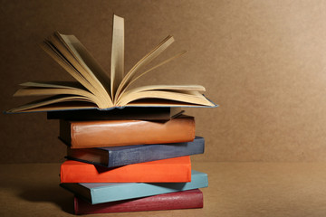Old books on shelf, close-up, on wooden background