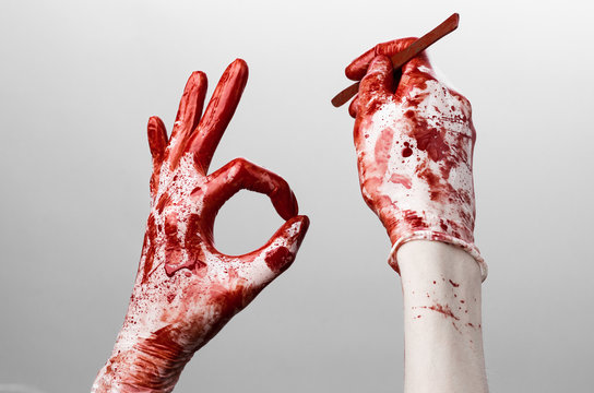 Bloody hands in gloves with the scalpel, white background
