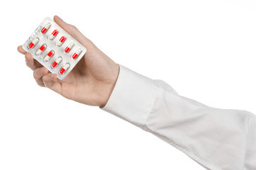 doctor's hand holding a red capsule for health isolated