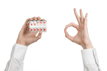 doctor's hand holding a red capsule for health isolated
