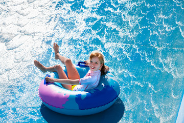 Child on water slide at aquapark.
