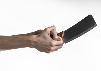Hand holding a knife for meat, chef holding a kitchen knife
