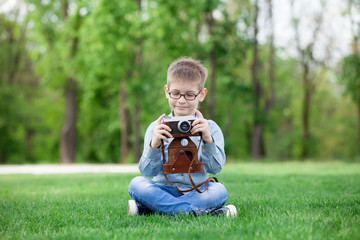 Fototapeta na wymiar young boy with a vintage camera
