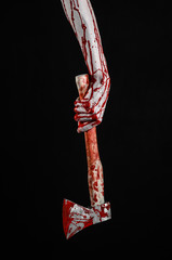 bloody hand holding a bloody butcher's ax isolated in studio - 83555512