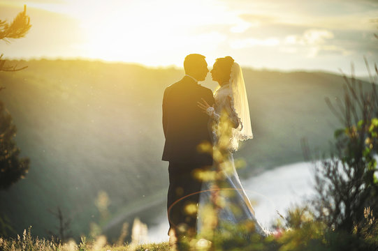 beautiful sunset and wedding couple on the high of mountain