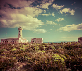 Fototapeta na wymiar Old lighthouse on the Murro di Porco cape