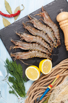 Fresh raw tiger prawns and fishing equipment