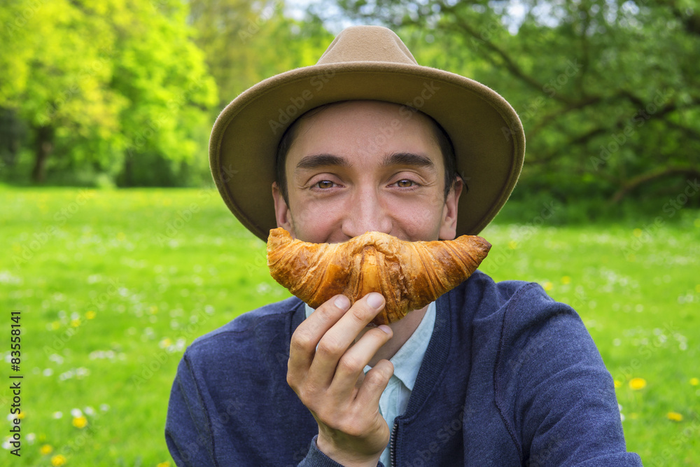 Wall mural man with croissant