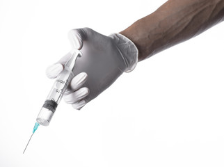 Doctor's hand holding a syringe, white-gloved hand