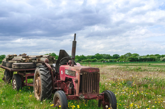 Abandoned Old Red Farm Tractor in Meadow