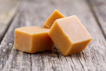 Tasty toffees on wooden background.