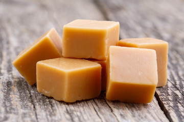 Tasty toffees on wooden background.