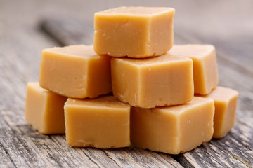 Tasty toffees on wooden background.
