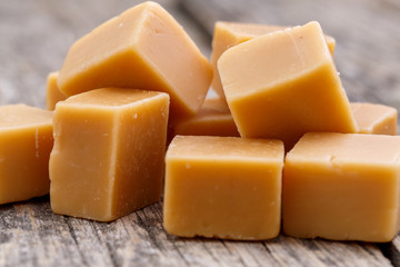 Tasty toffees on wooden background.