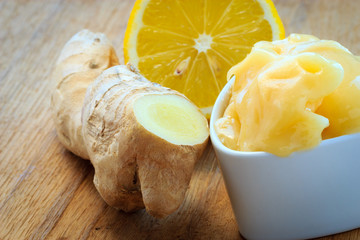 ginger root, honey and lemon on wooden rustic table.