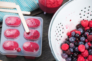 making homemade summer fruit lolly pops