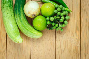 Huge group of fresh vegetables and fruit on wooden background