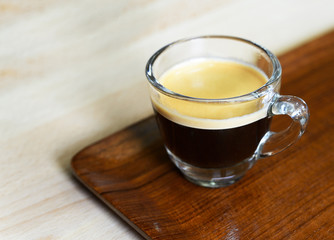 Cup of espresso coffee on wood tray