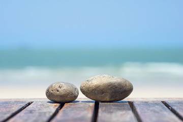 Stones on table with sea and sky background