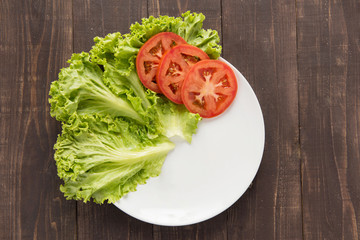 empty plate with tomatoes and vegetable waiting for food.