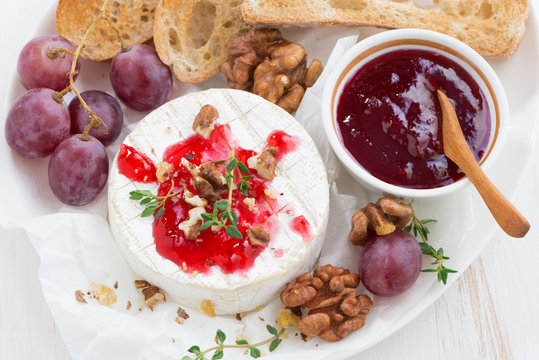 camembert with berry jam and toasts, top view