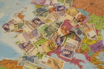 Four different currencies laid out on the map of Europe