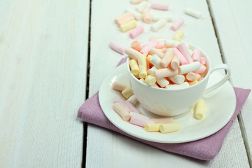 marshmallow in a cup on a wooden background