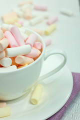 marshmallow in a cup on a wooden background