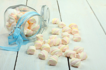 marshmallow in a glass on a wooden background