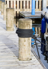 Rope knot on Pillar wooden at pier.