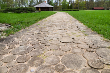 Wooden round log path closeup in summer recreation camping site