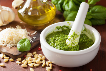pesto sauce and ingredients over wooden rustic background - obrazy, fototapety, plakaty