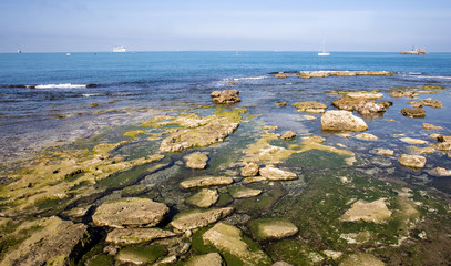 seascape with transparent sea and surfacing rocks