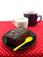 sweet brownies or chocolate cakes cakes on plaid tablecloth