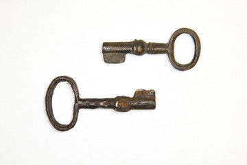 A lot vintage keys from the locks on a white background