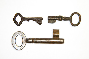 A lot vintage keys from the locks on a white background
