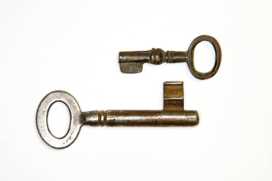 A lot vintage keys from the locks on a white background