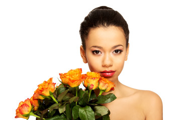 Fototapeta premium Beauty african woman with roses.