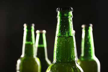 Glass bottles of beer on dark background