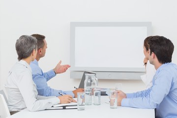 Business team looking at white screen