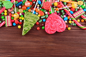 Colorful candies on wooden background