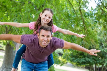 Father and daughter having fun in the park