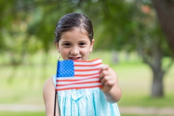 Little girl waving american flag