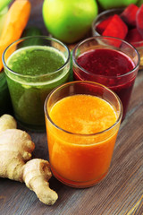 Assortment of healthy fresh juices on wooden table background