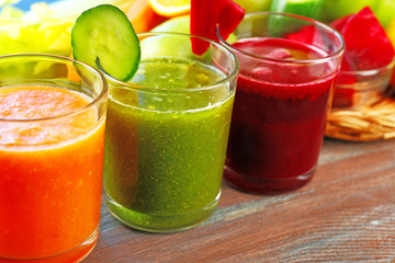 Assortment of healthy fresh juices on wooden table background