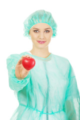 Female doctor with heart model.