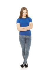Teenage woman with crossed arms.