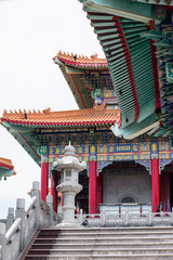 Colorful Buddhist Chinese temple in Thailand with blue sky .