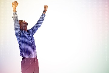 Composite image of excited businessman cheering