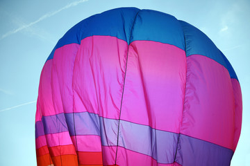 large colorful hot air balloon is flying in the sky